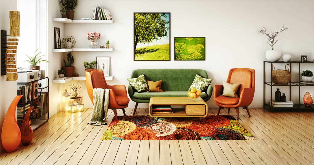 Retro design interior of living lounge space. Green loveseat, terracotta colored chairs, botanical art pieces, patterned carpet.