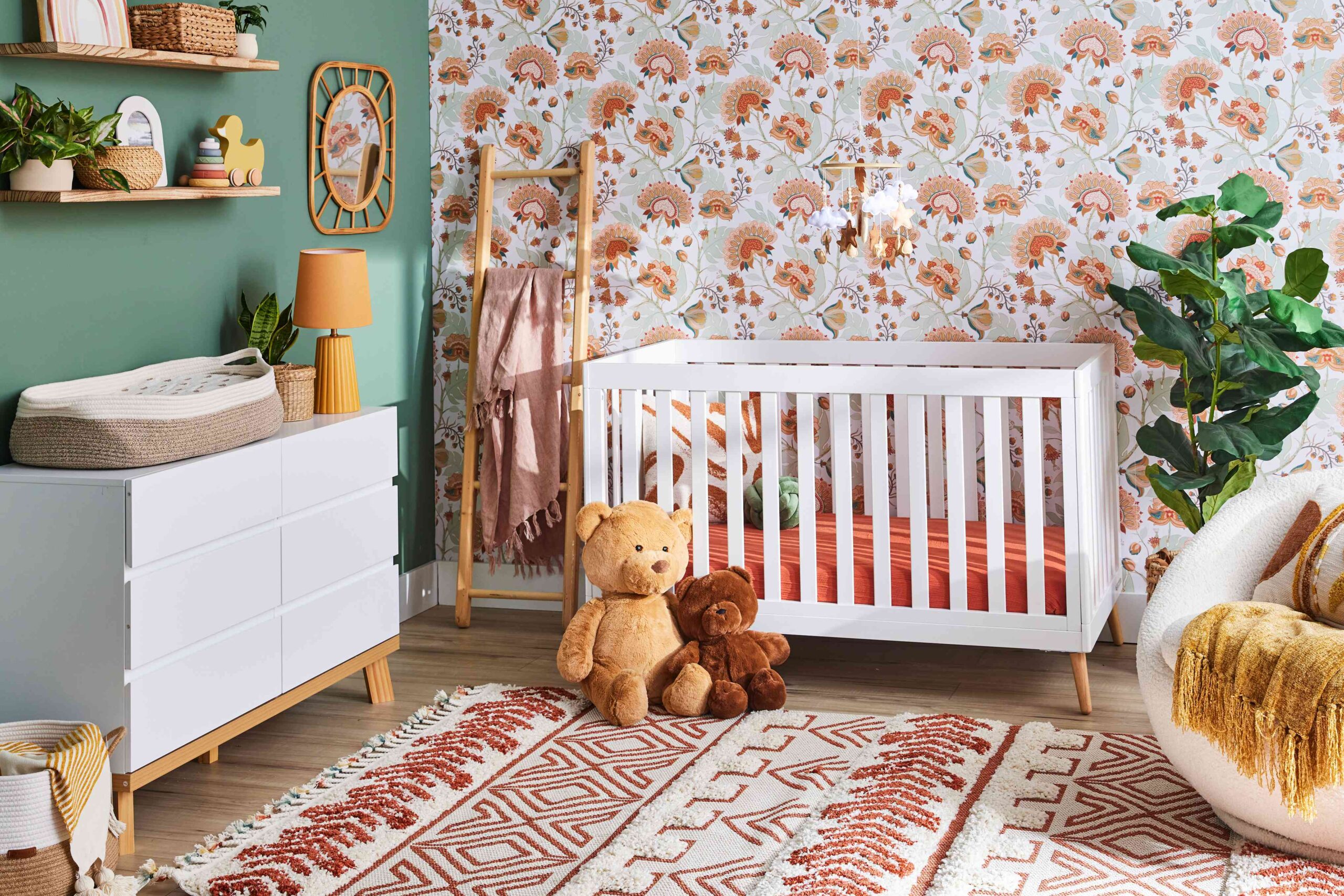 colorful baby nursery with pink floral patterns and teddy bears