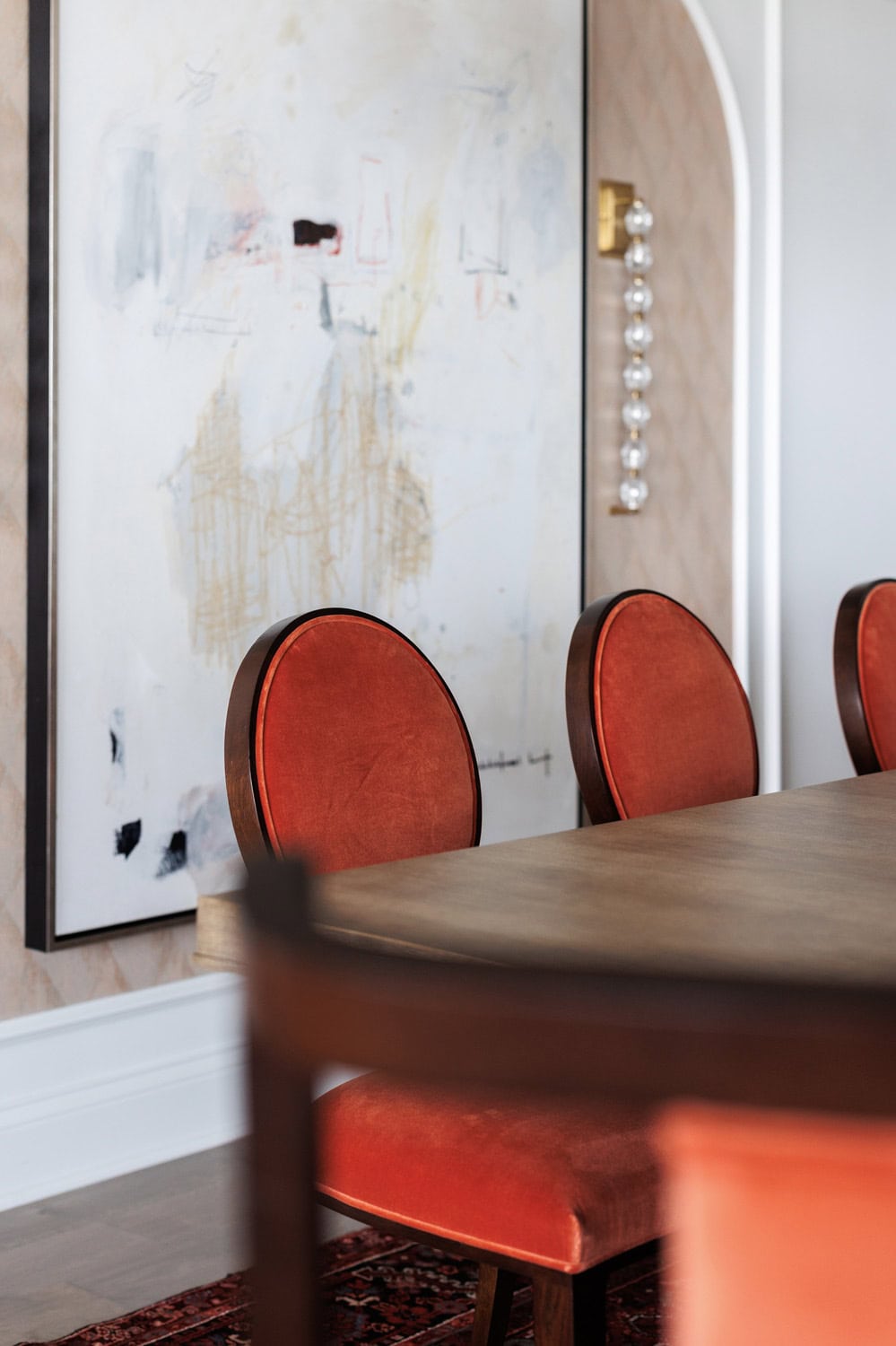 A table with chairs and a painting on the wall.