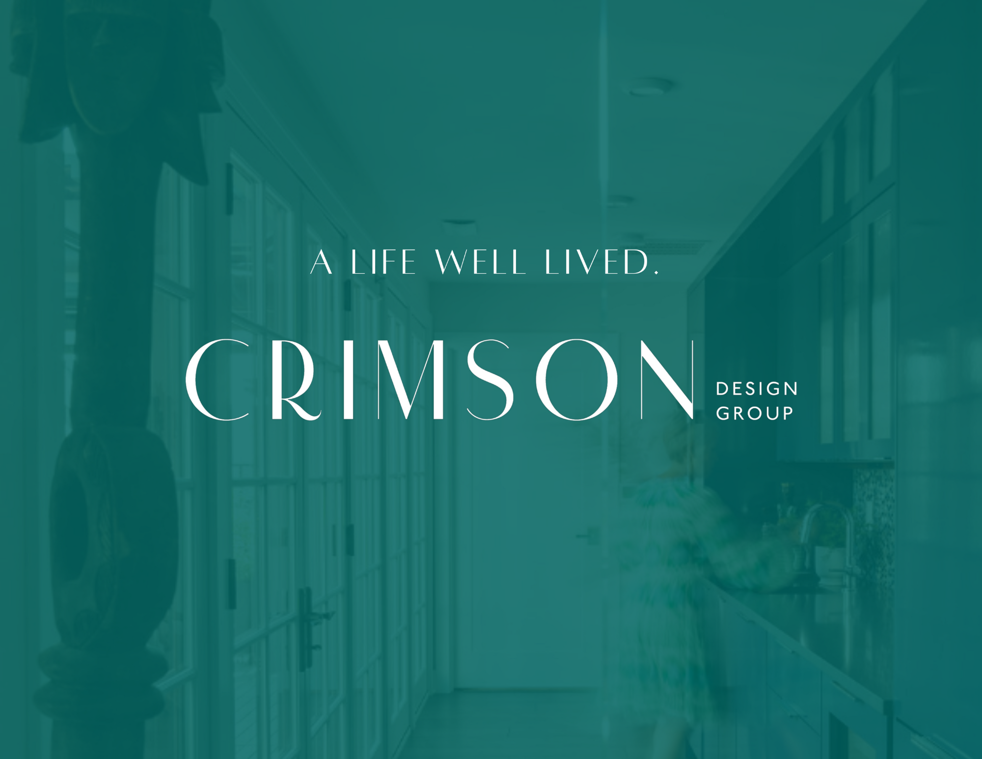 Overlay text reads "A Life Well Lived. Crimson Design Group" on a teal-tinted photo featuring a person in a modern kitchen designed by Crimson Design Group, with sleek cabinets and abundant natural light.