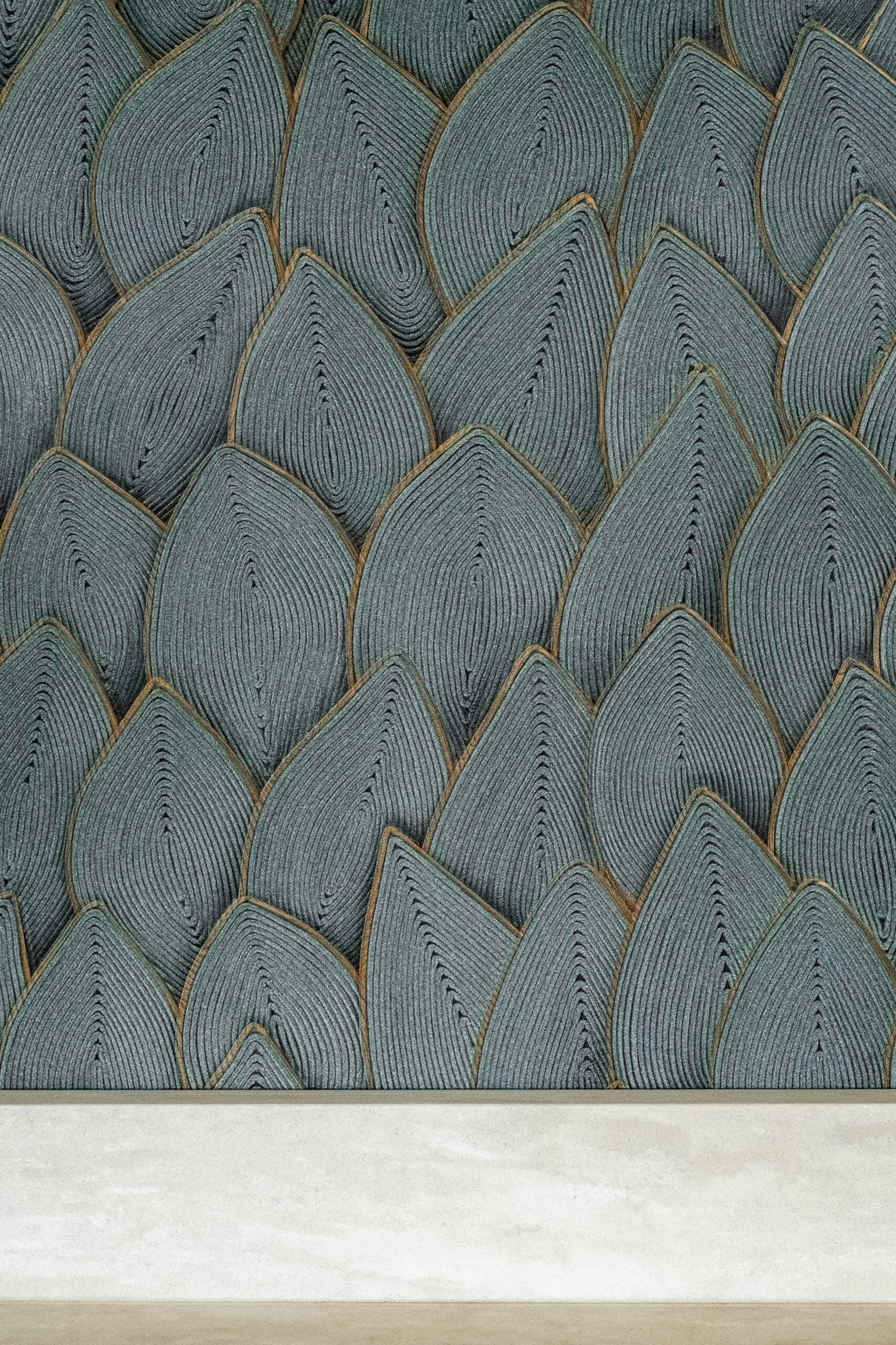 Patterned surface resembling overlapping teardrop-shaped tiles in gray tones with fine black lines, bordered by a solid light-colored strip at the bottom.