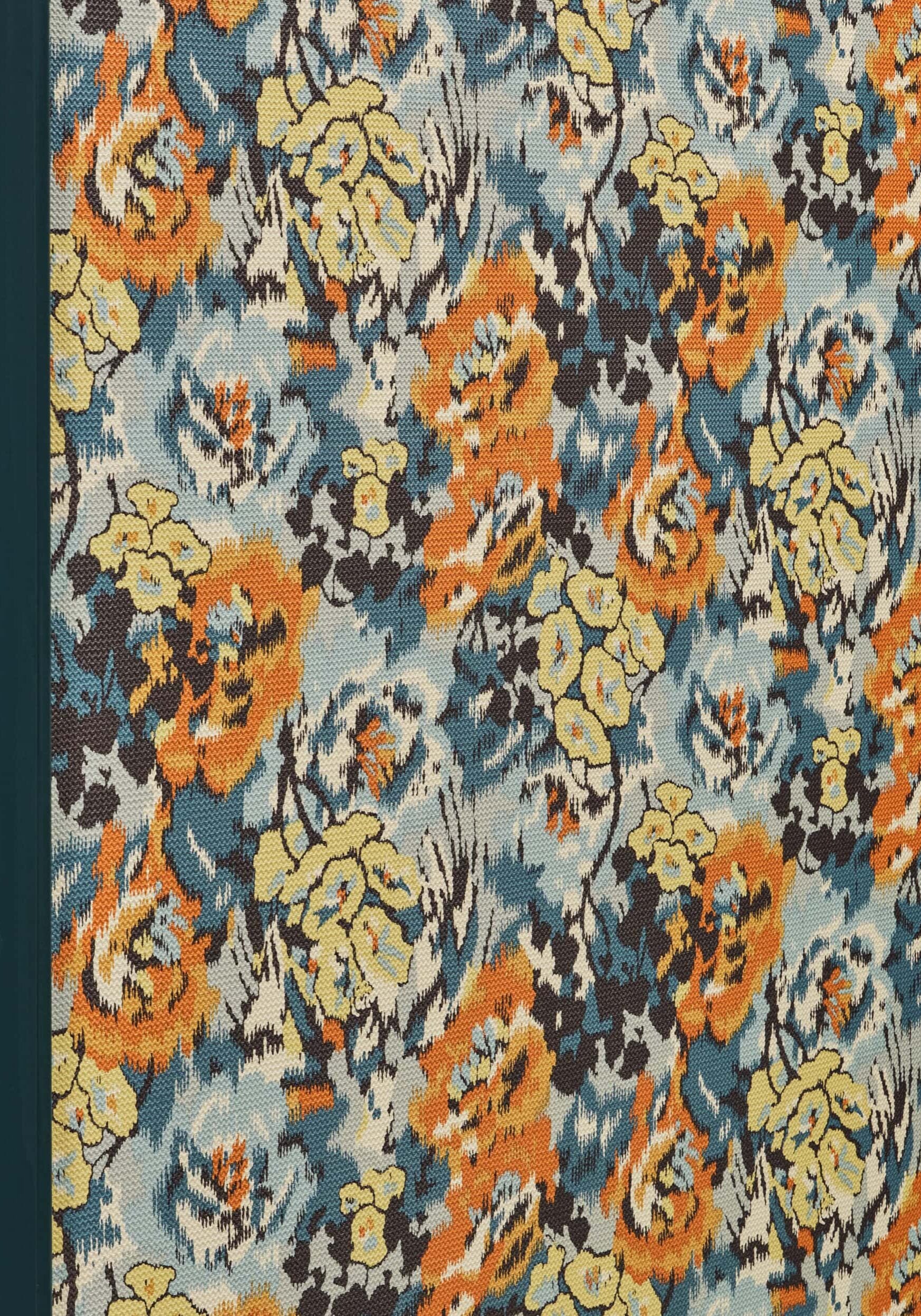 Floral patterned fabric with orange, yellow, blue, and brown colors displayed vertically.