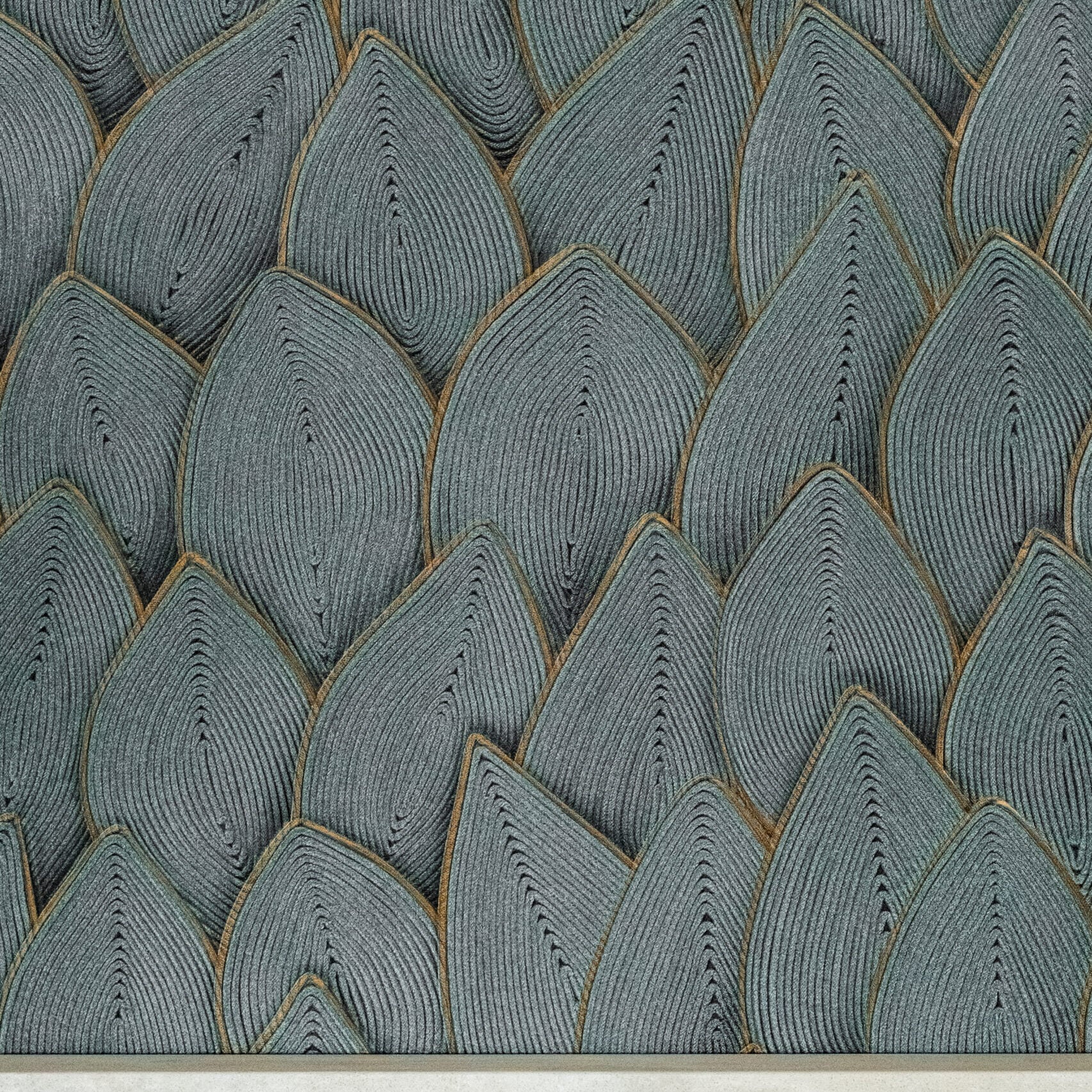 Patterned surface resembling overlapping teardrop-shaped tiles in gray tones with fine black lines, bordered by a solid light-colored strip at the bottom.