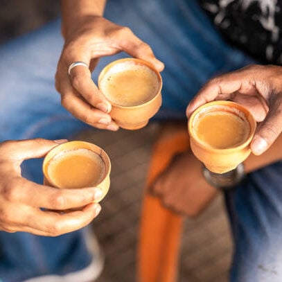 Tea or chai served in earthen cup or khulhad, Three cups of tea with milk tea.